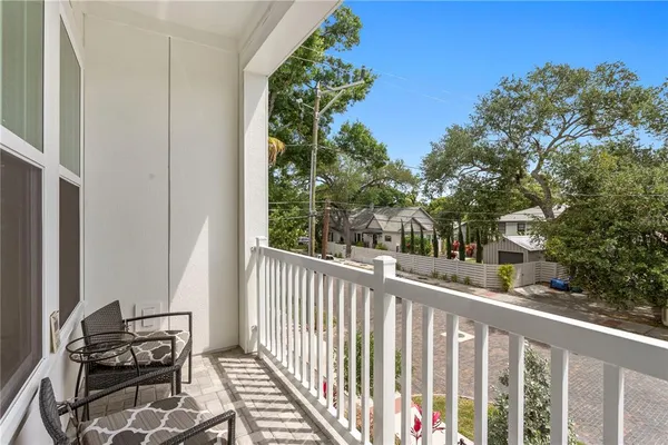 a view of a balcony with wooden fence