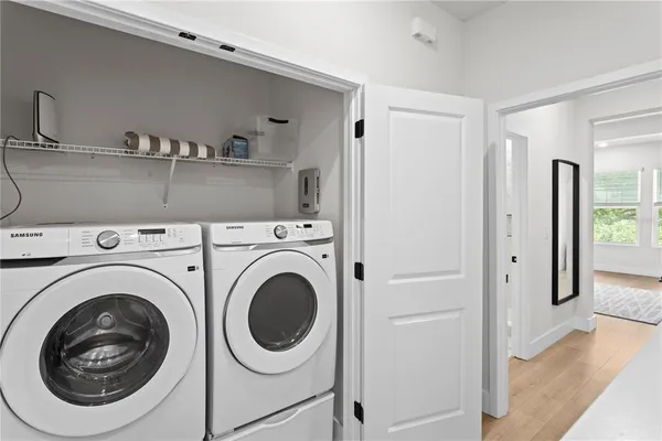 a view of a hallway with washer and dryer