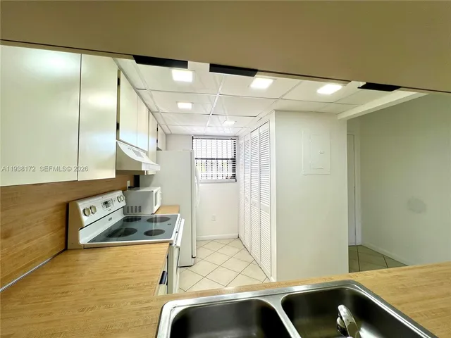 a kitchen with stainless steel appliances granite countertop a sink and a refrigerator
