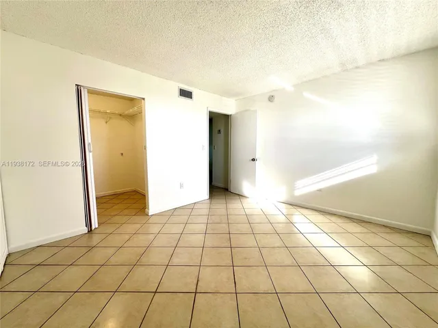 a view of a livingroom with an empty space and a window