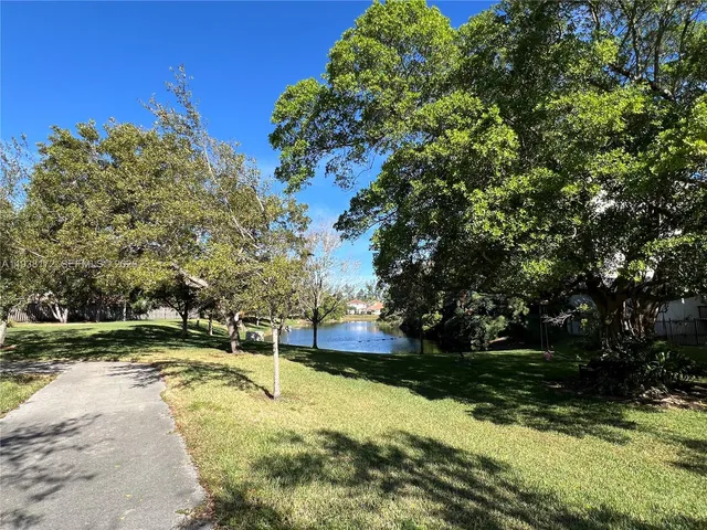 a view of a swimming pool with an outdoor seating and a yard