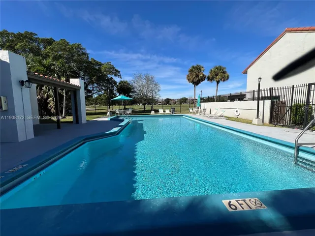 a view of a backyard with sitting area