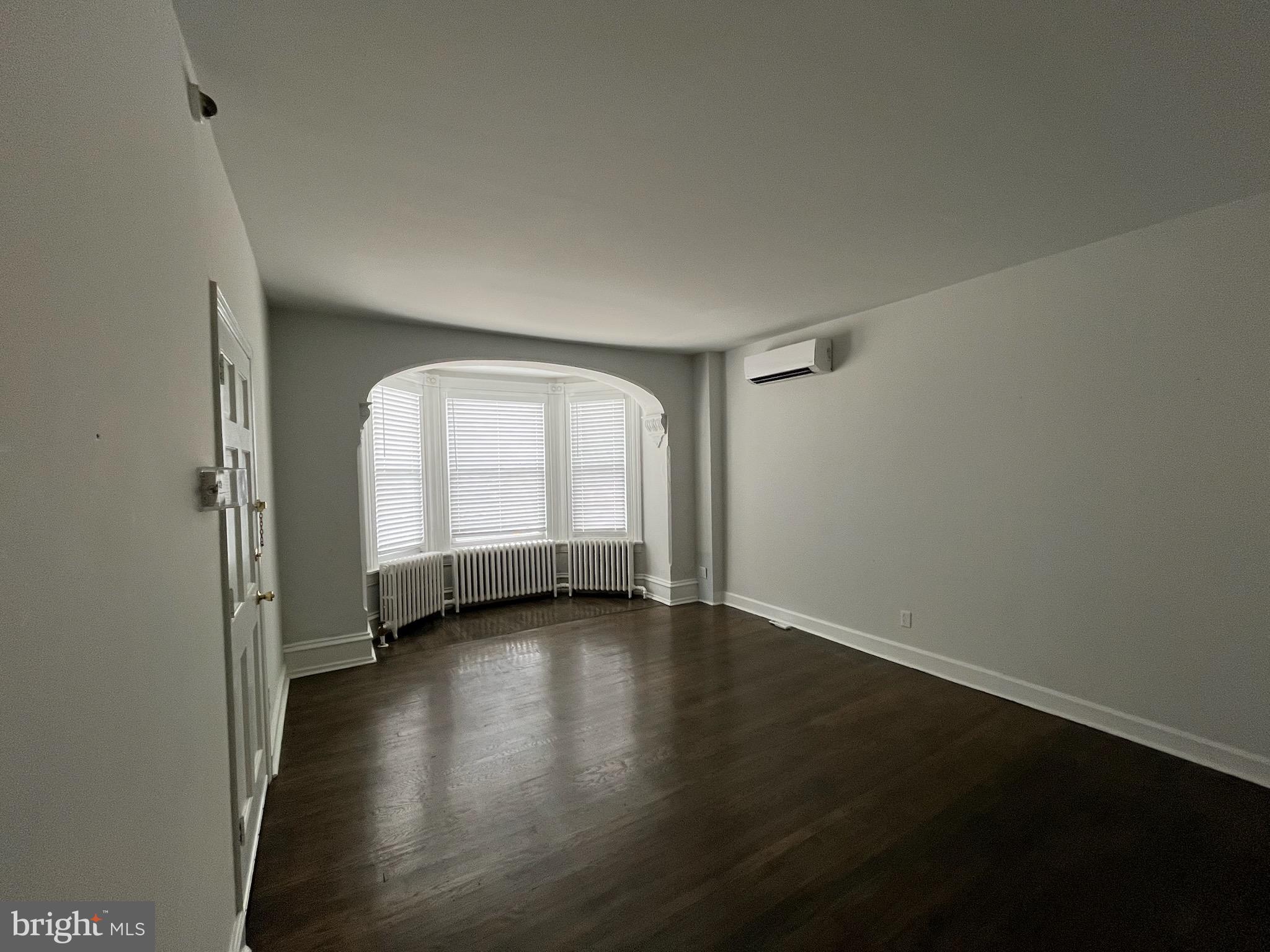 357 Lyceum Avenue, Unit A Philadelphia, PA 19128 - Photo 13 of 14 an empty room with wooden floor and windows