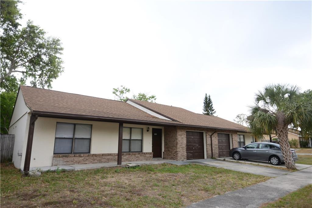 5410 Decatur Street Orlando, FL 32807 - Photo 1 of 1 a front view of a house with a yard and garage