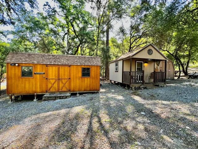 a view of a house with a yard and wooden fence