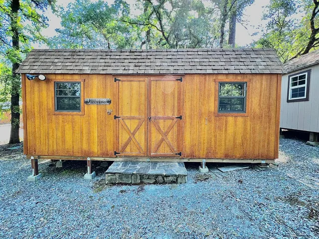 a view of a small yard with wooden fence