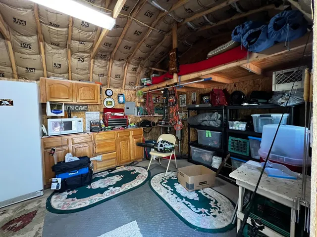 a room with lots of furniture and white walls