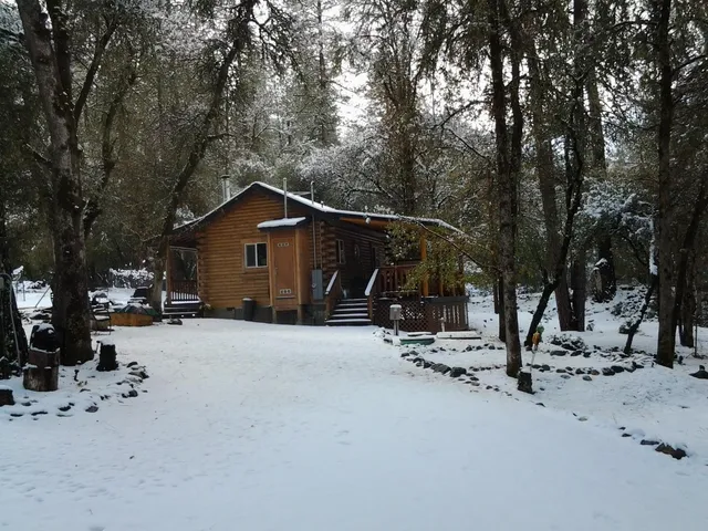 a view of a backyard with table and chairs