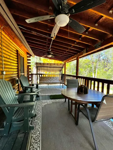 a backyard of a house with wooden seating outdoor seating