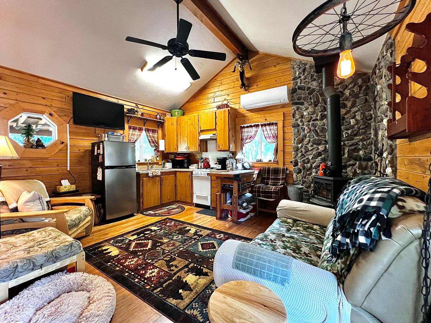 9110 Hidden Valley Road Mountain Ranch, CA 95246 - Photo 10 of 44 a living room with furniture a fireplace and a flat screen tv