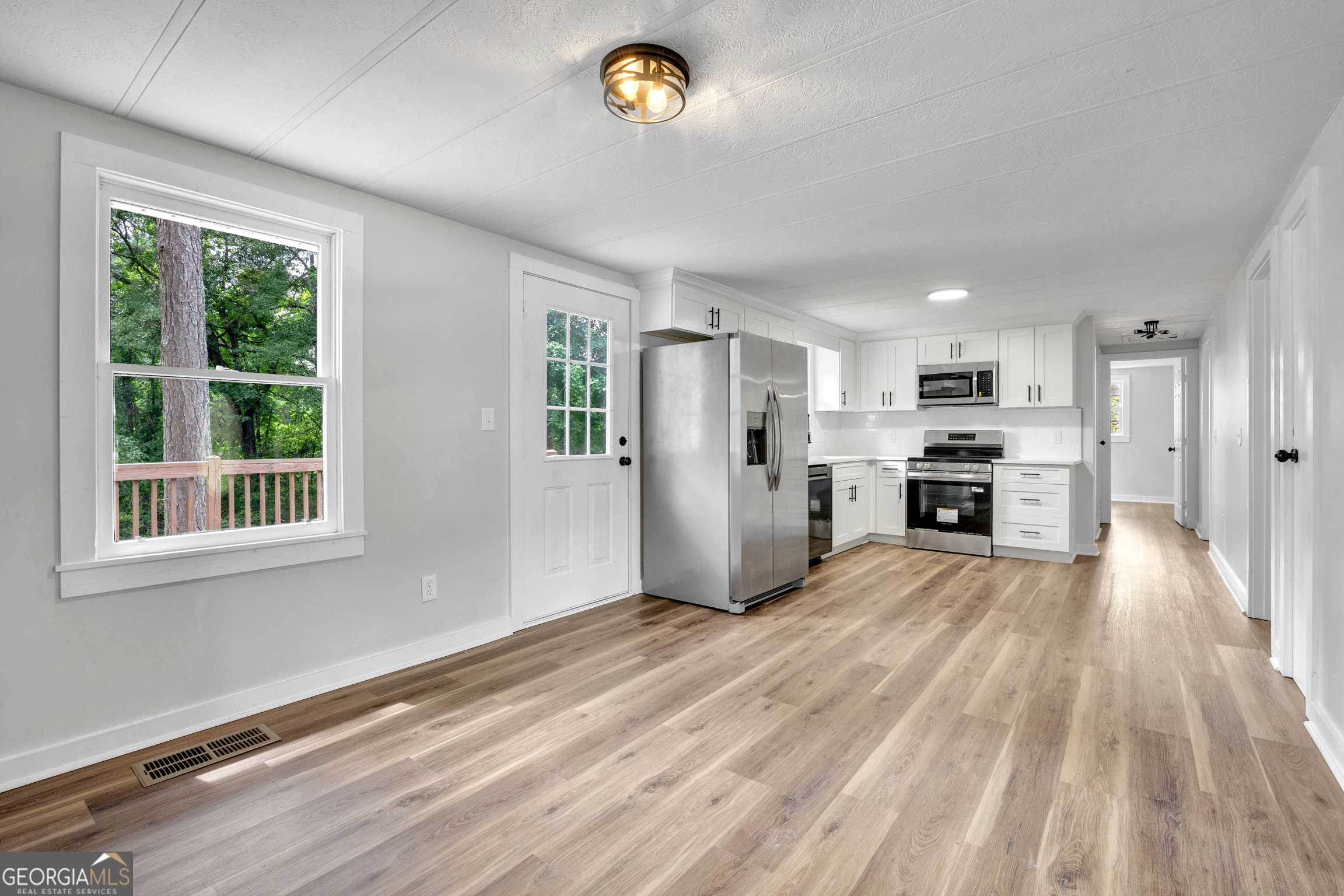 455 Cindy Street Jackson, GA 30233 - Photo 10 of 25 a view of a kitchen with a stove cabinets and wooden floor