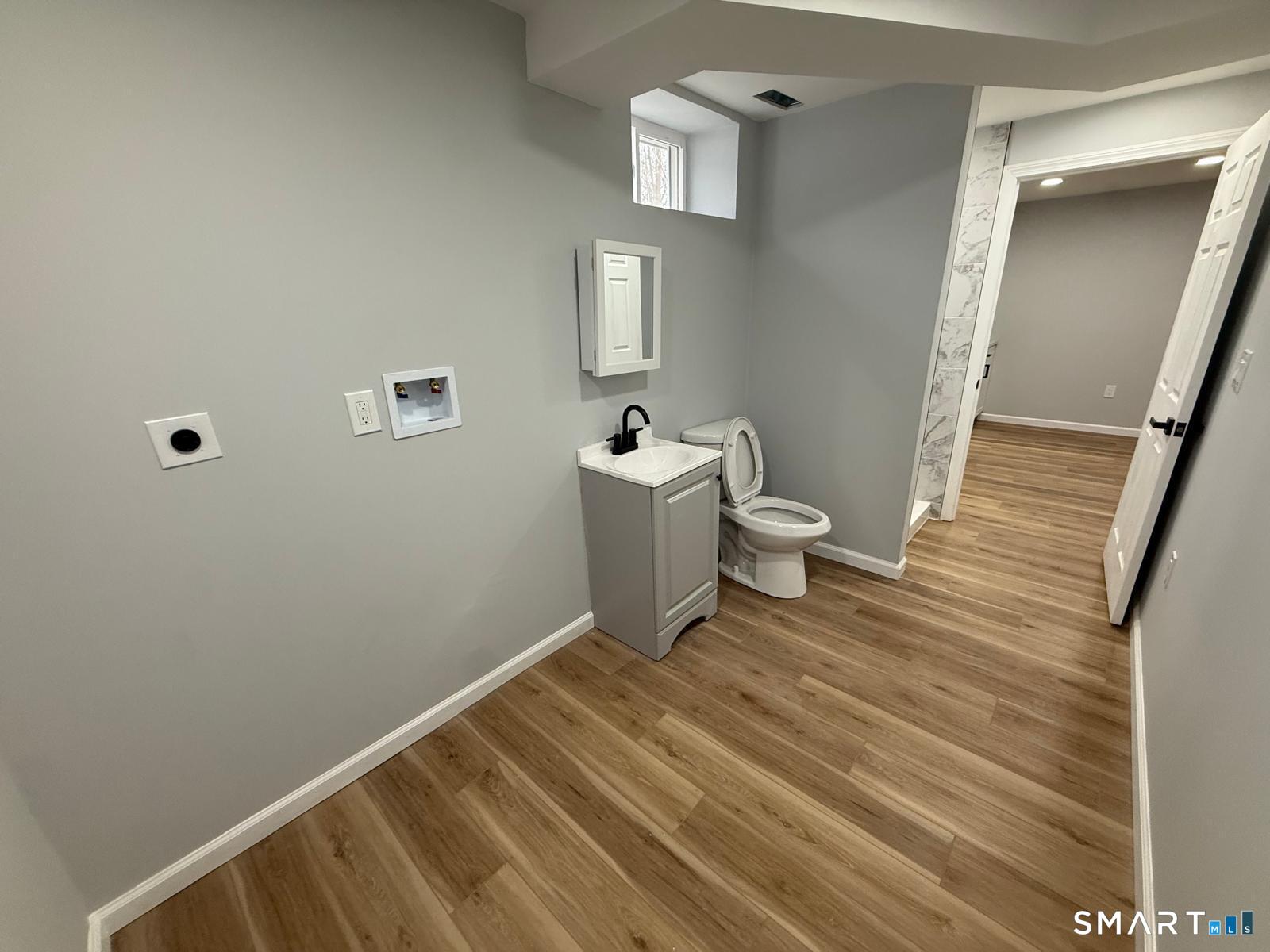 46 Bracewood Road Waterbury, CT 06706 - Photo 12 of 25 a bathroom with a sink a toilet and mirror