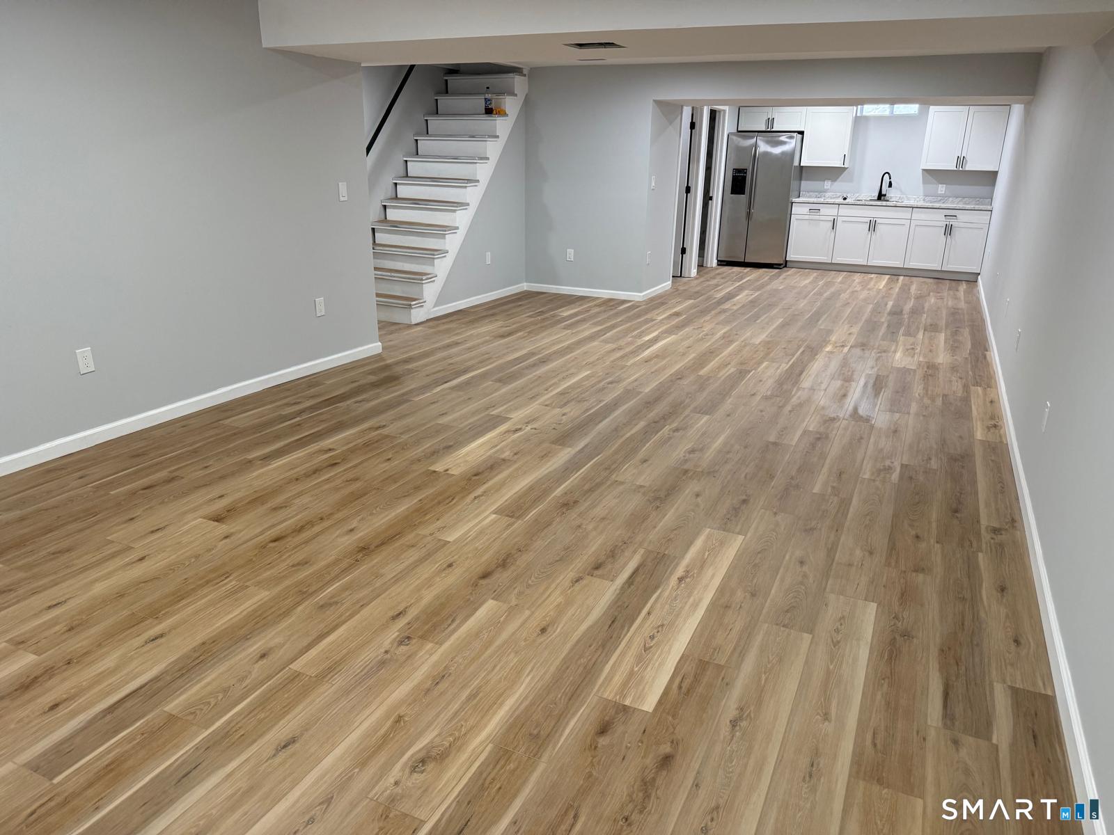 46 Bracewood Road Waterbury, CT 06706 - Photo 14 of 25 a view of a room with wooden floor and stairs