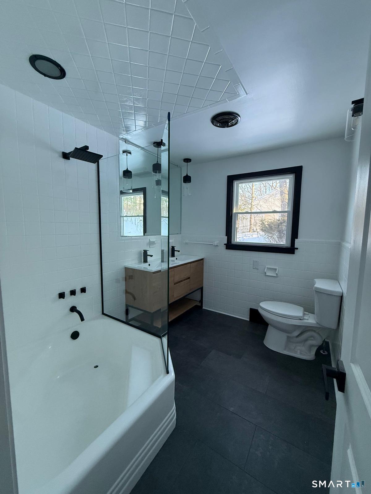 46 Bracewood Road Waterbury, CT 06706 - Photo 16 of 25 a bathroom with a tub sink and mirror