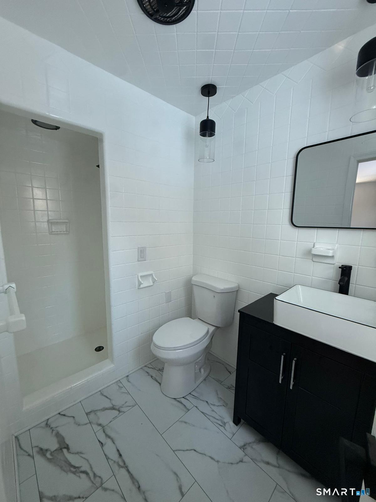 46 Bracewood Road Waterbury, CT 06706 - Photo 17 of 25 a bathroom with a sink toilet vanity and shower