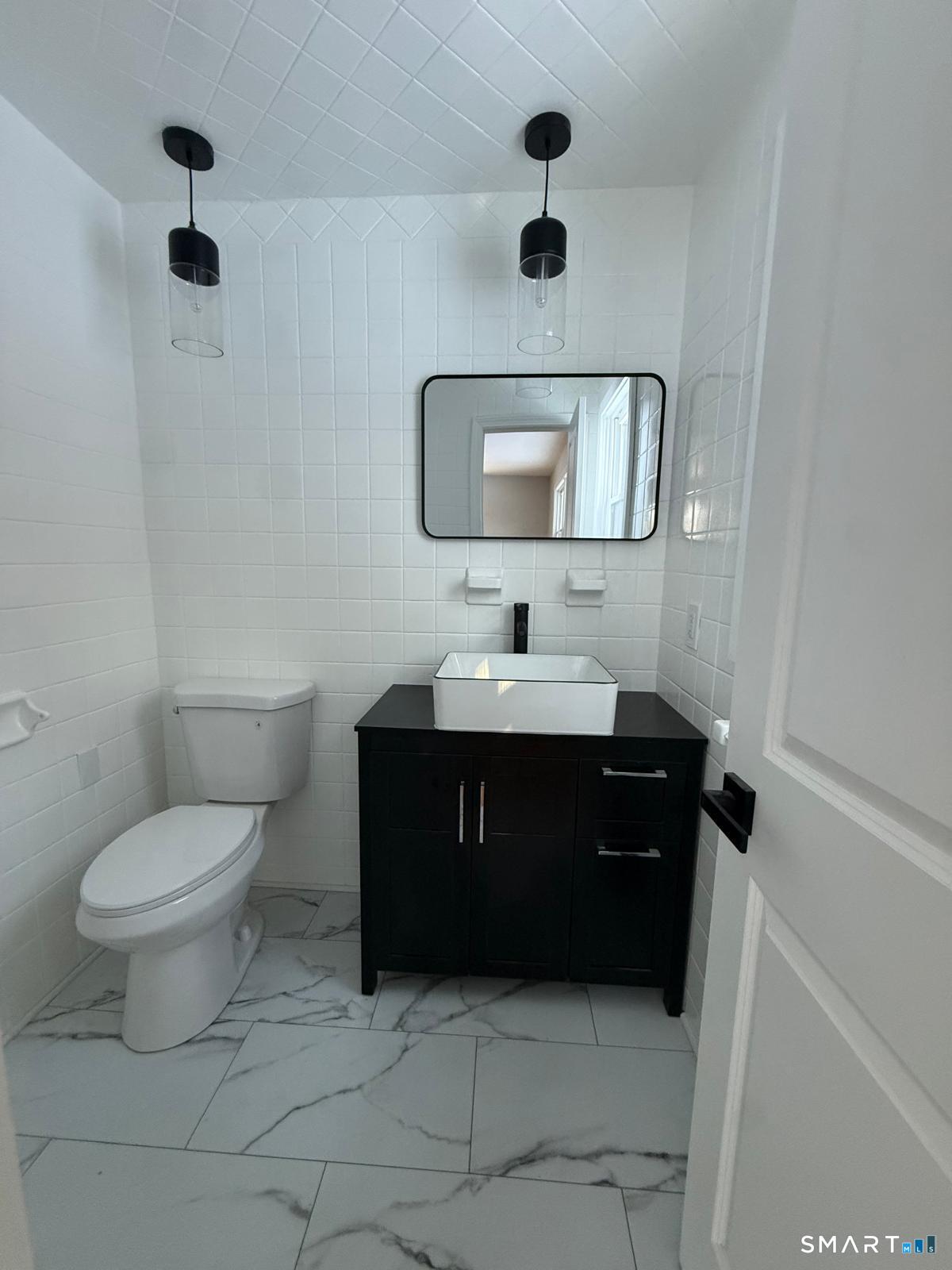 46 Bracewood Road Waterbury, CT 06706 - Photo 18 of 25 a bathroom with a toilet sink and mirror