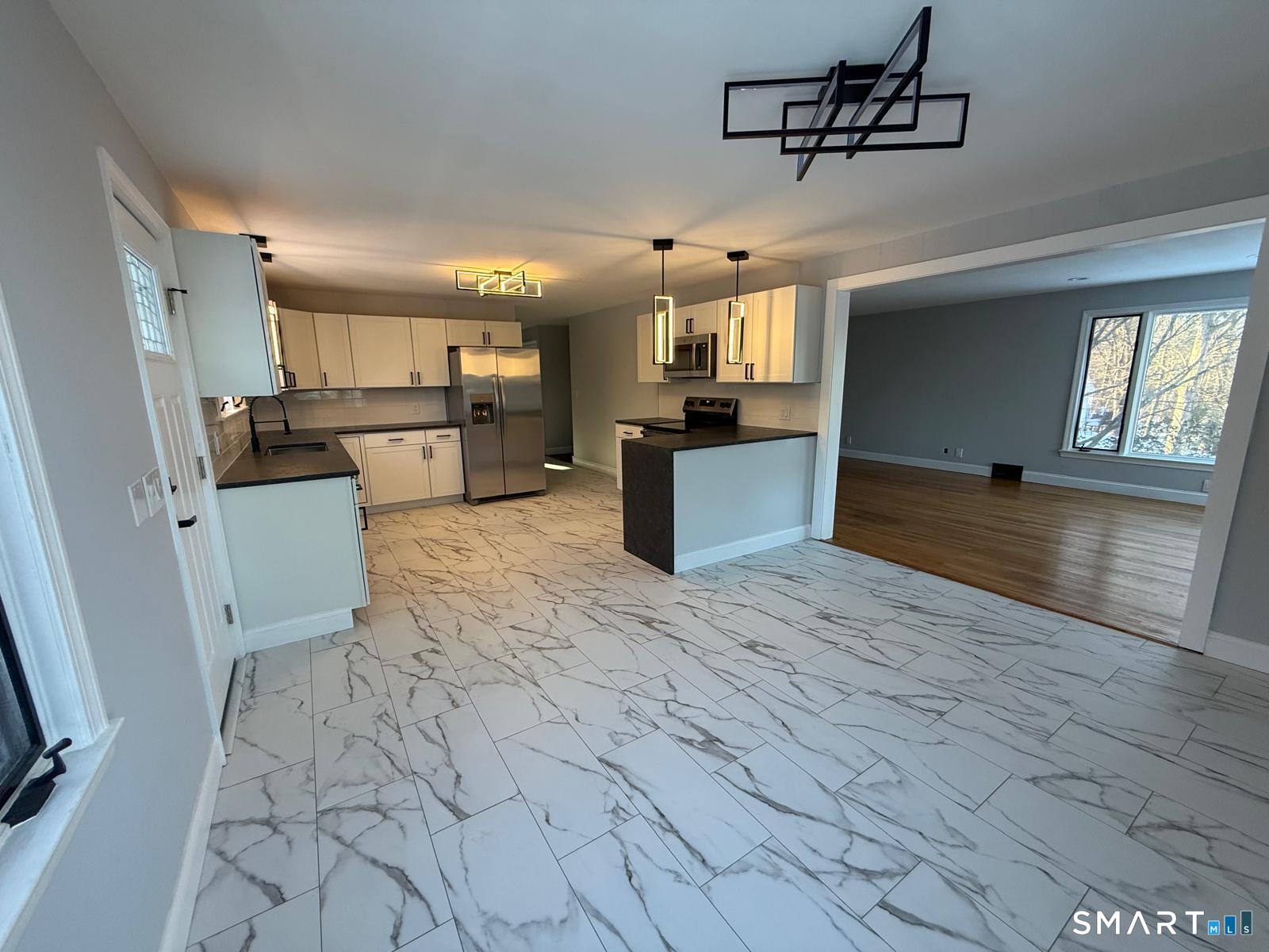 46 Bracewood Road Waterbury, CT 06706 - Photo 19 of 25 a kitchen with stainless steel appliances kitchen island granite countertop a stove and a sink