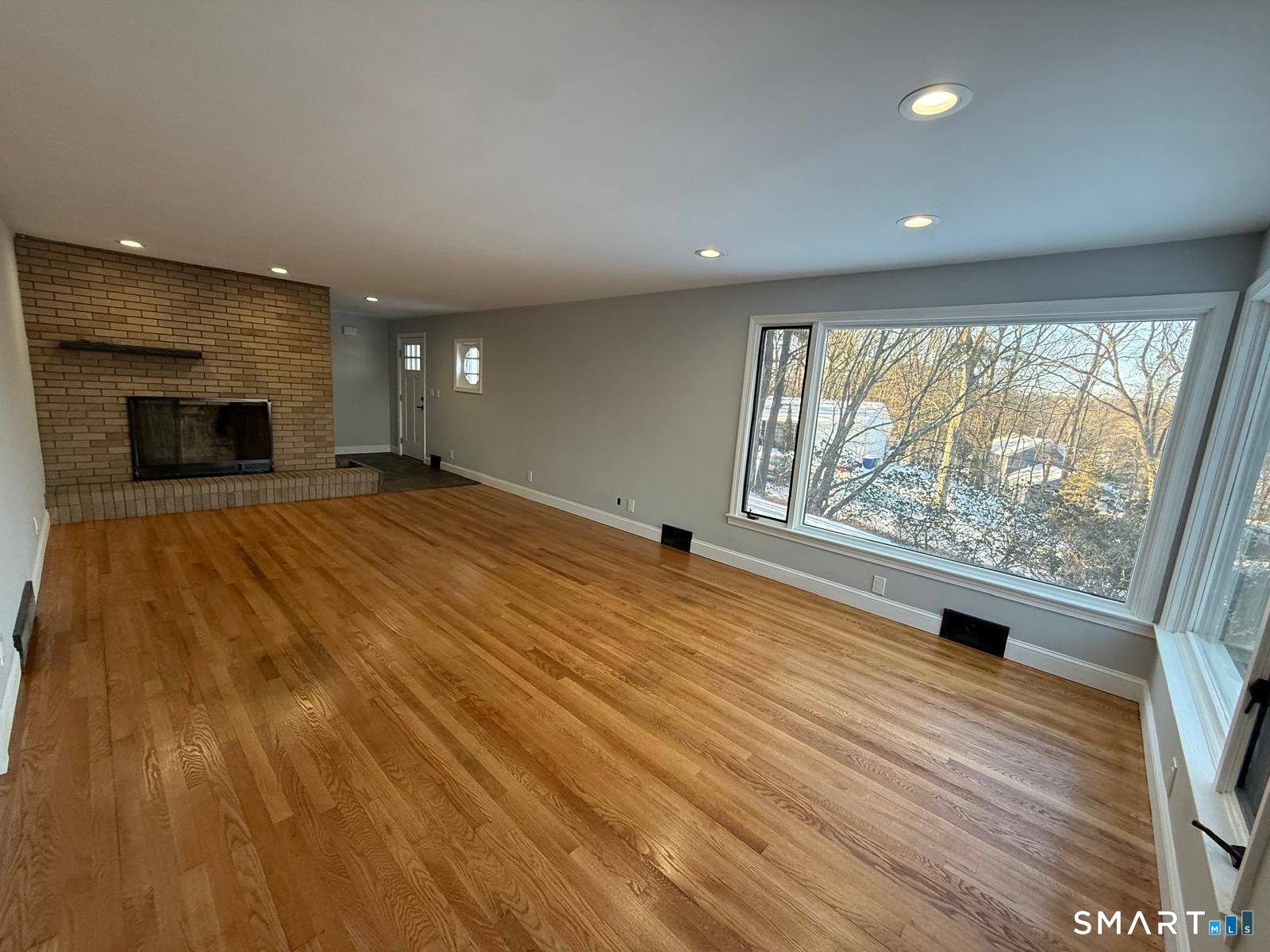 46 Bracewood Road Waterbury, CT 06706 - Photo 21 of 25 an empty room with wooden floor and windows