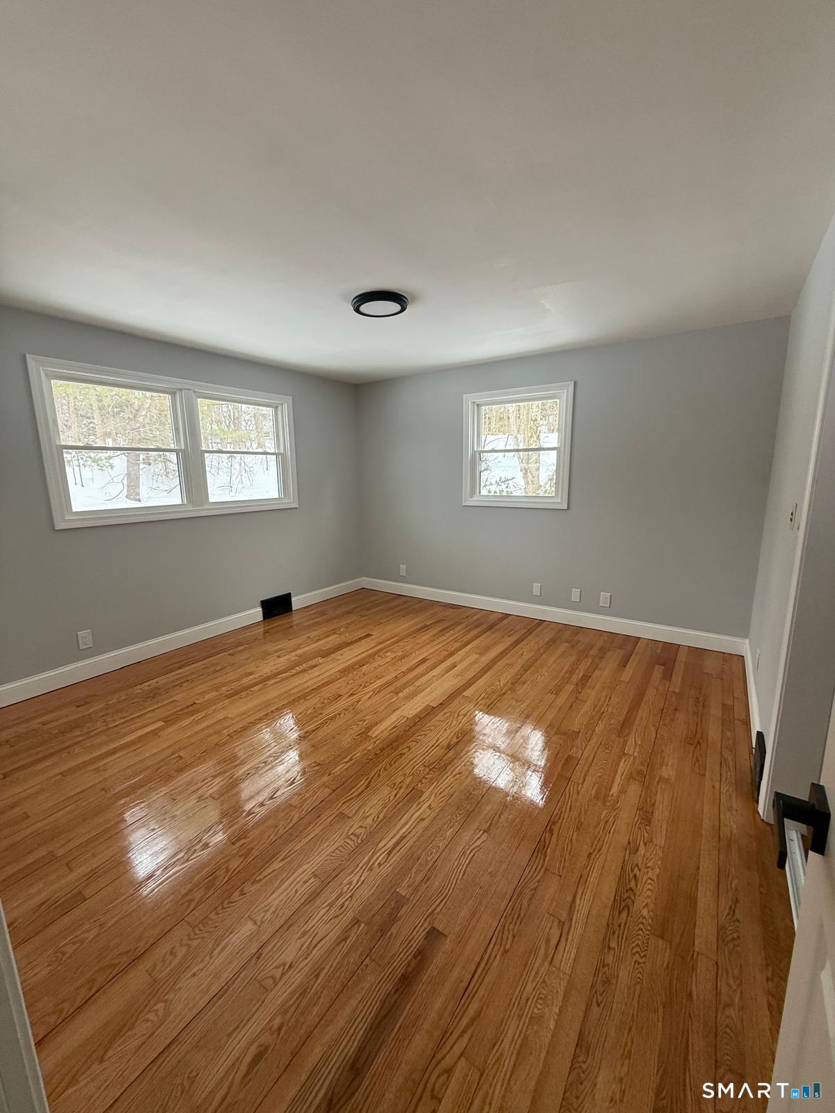 46 Bracewood Road Waterbury, CT 06706 - Photo 8 of 25 a view of empty room with wooden floor and fan