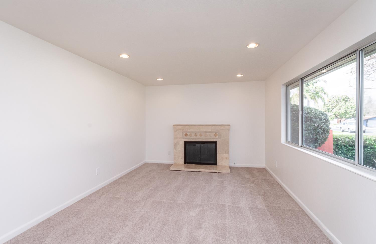 6312 Trenton Way Citrus Heights, CA 95621 - Photo 11 of 27 an empty room with fireplace and windows