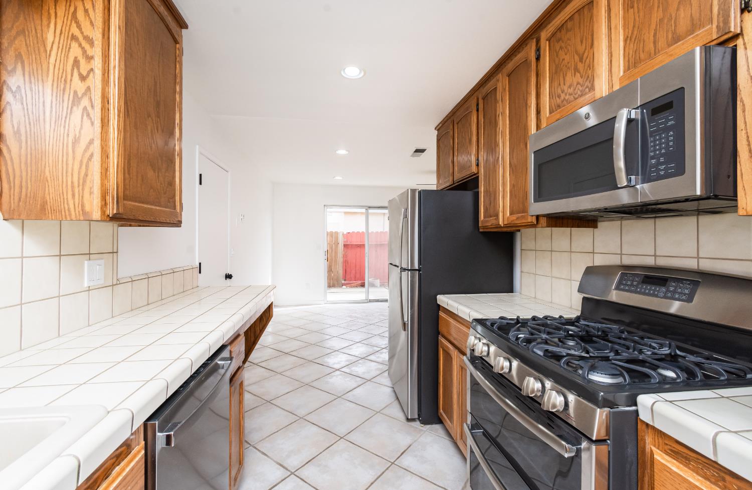6312 Trenton Way Citrus Heights, CA 95621 - Photo 7 of 27 a kitchen with stainless steel appliances granite countertop a stove a sink and a microwave