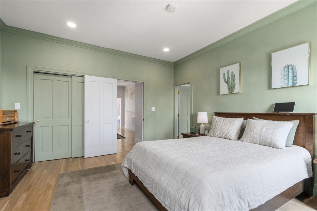 48 Mt Vernon Street, Unit 3 Boston, MA 02129 - Photo 13 of 31 a bedroom with a large bed and painting on the wall