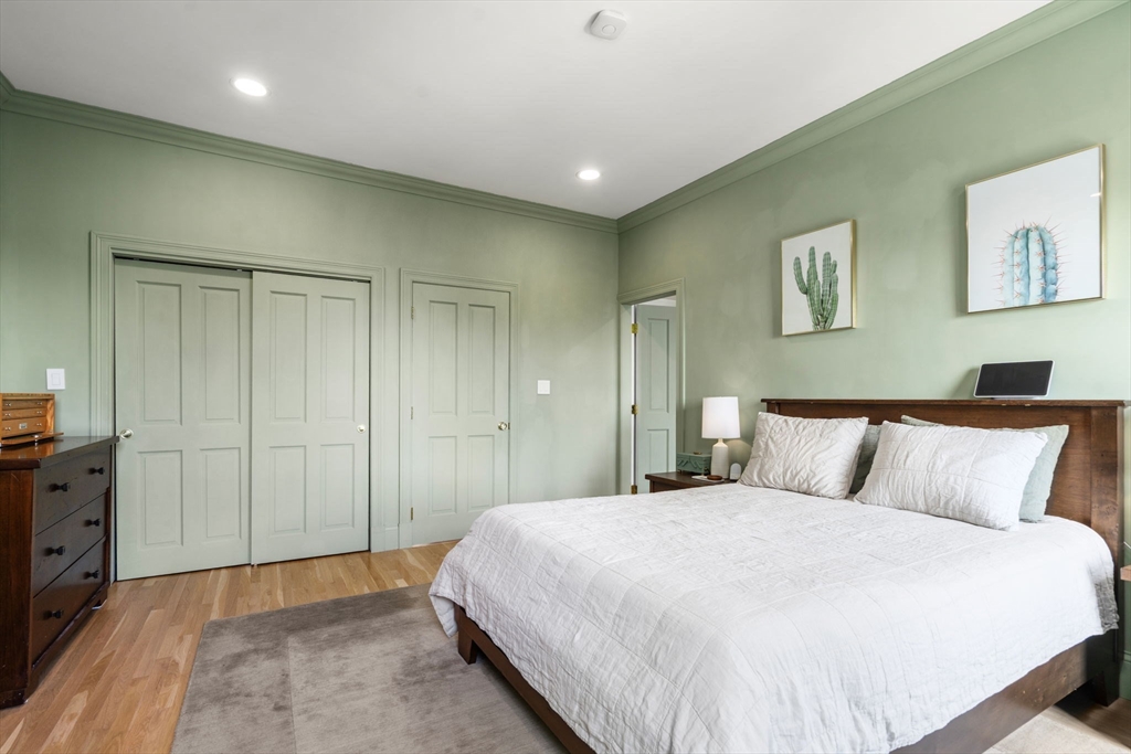 48 Mt Vernon Street, Unit 3 Boston, MA 02129 - Photo 14 of 31 a bedroom with a large bed and painting on the wall