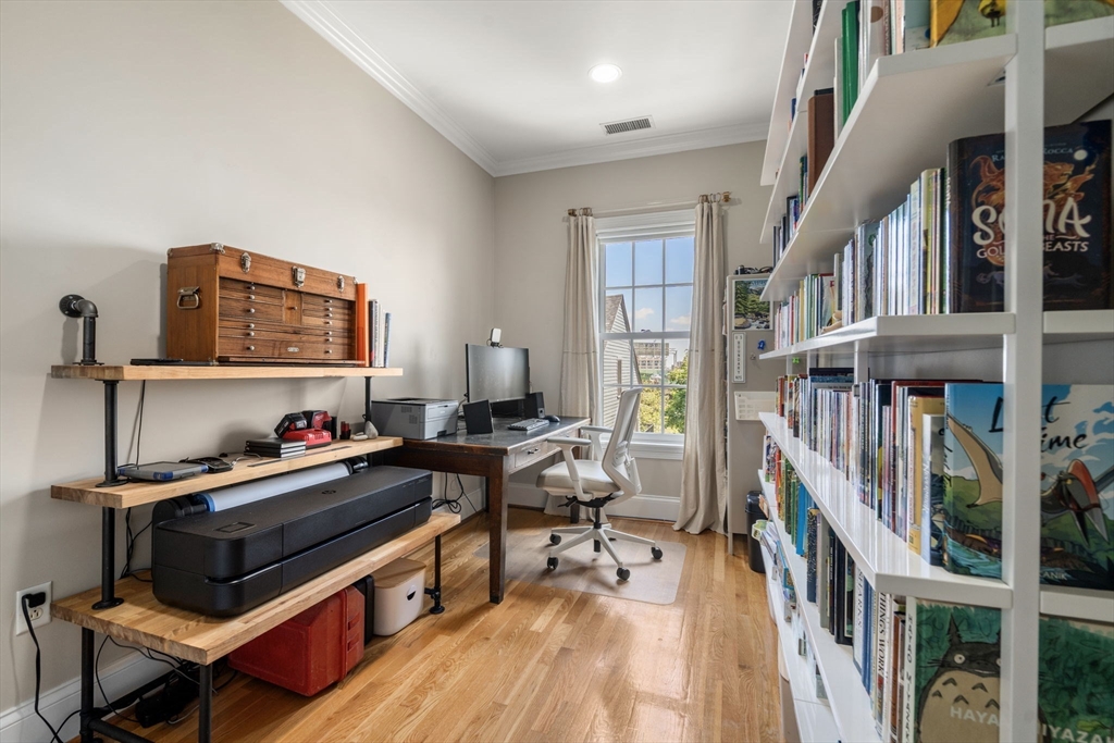 48 Mt Vernon Street, Unit 3 Boston, MA 02129 - Photo 16 of 31 a living room with furniture and a book shelf