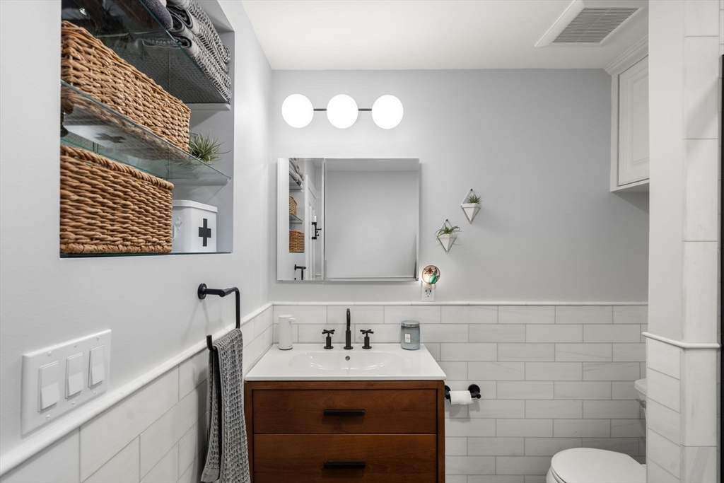 48 Mt Vernon Street, Unit 3 Boston, MA 02129 - Photo 21 of 31 a bathroom with a sink vanity and a mirror