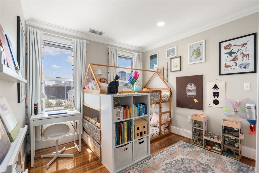 48 Mt Vernon Street, Unit 3 Boston, MA 02129 - Photo 22 of 31 a living room with furniture and a book shelf