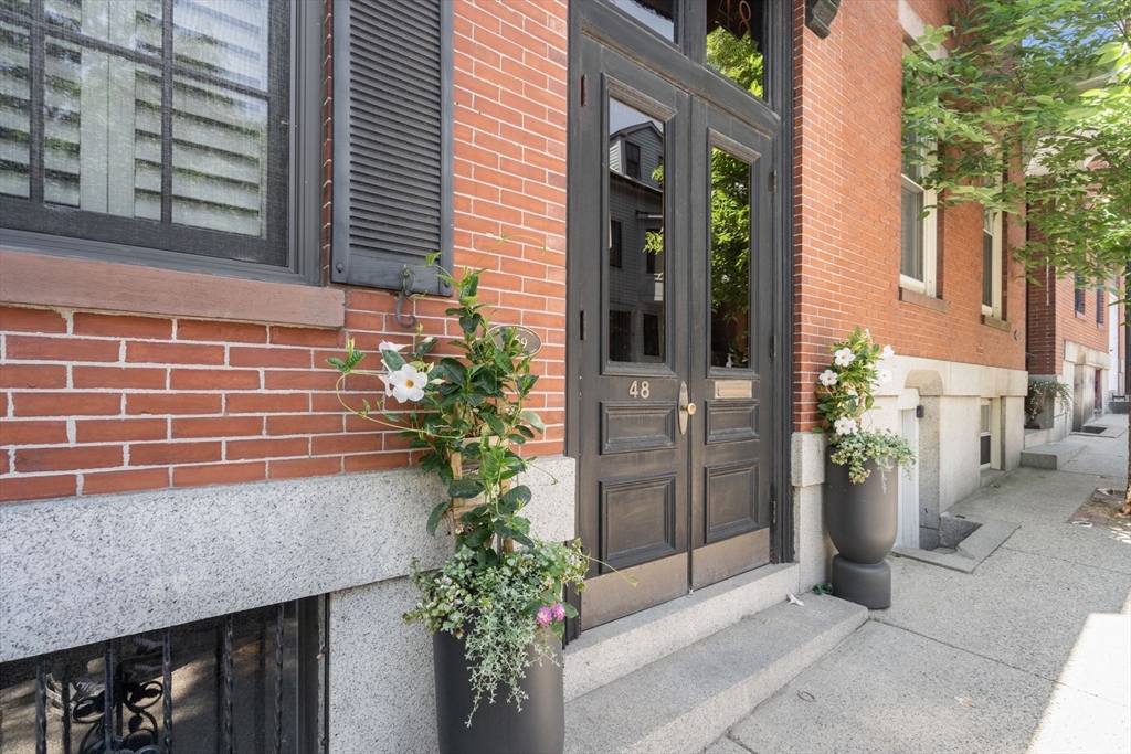 48 Mt Vernon Street, Unit 3 Boston, MA 02129 - Photo 30 of 31 a potted plant sitting in front of a house