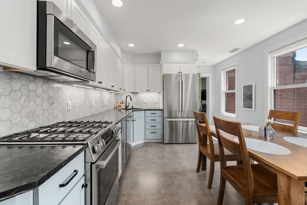 48 Mt Vernon Street, Unit 3 Boston, MA 02129 - Photo 8 of 31 a kitchen with stainless steel appliances granite countertop a stove a sink dishwasher a refrigerator and cabinets with wooden floor
