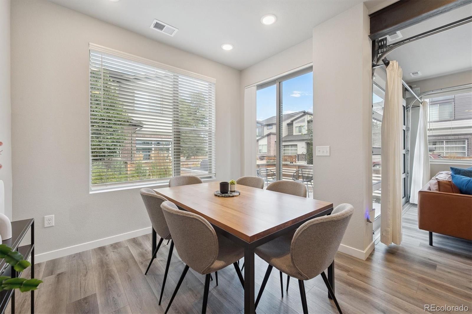 11772 West 45th Place Wheat Ridge, CO 80033 - Photo 11 of 25 a view of a dining room with furniture window and wooden floor