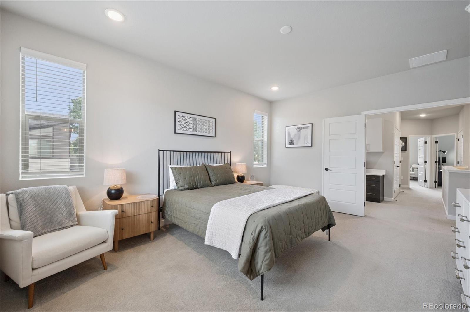 11772 West 45th Place Wheat Ridge, CO 80033 - Photo 15 of 25 a spacious bedroom with a bed and a couch