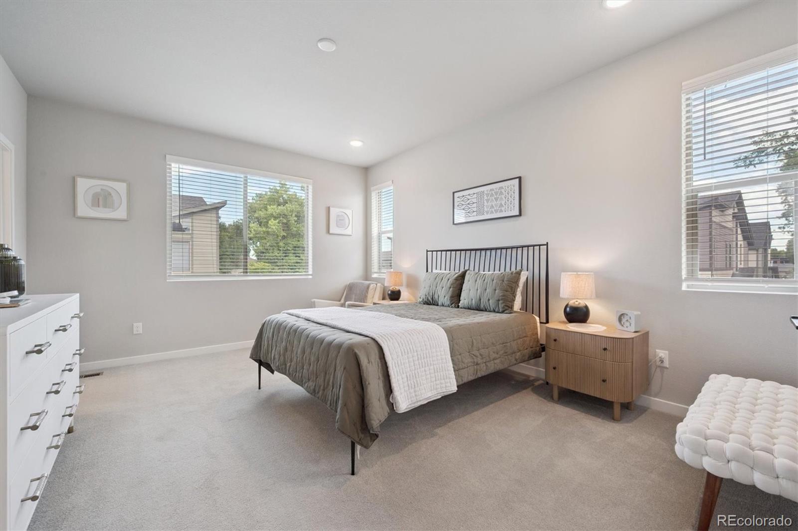 11772 West 45th Place Wheat Ridge, CO 80033 - Photo 16 of 25 a spacious bedroom with a bed and window