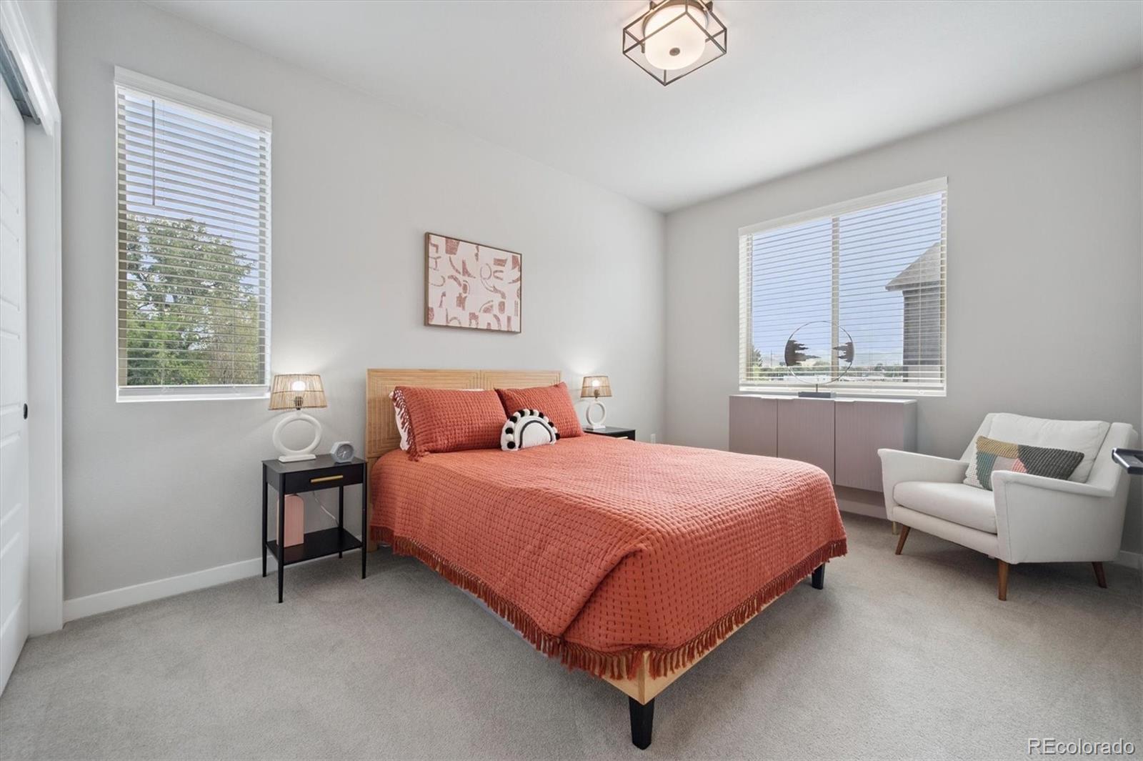 11772 West 45th Place Wheat Ridge, CO 80033 - Photo 18 of 25 a bedroom with a bed and a couch