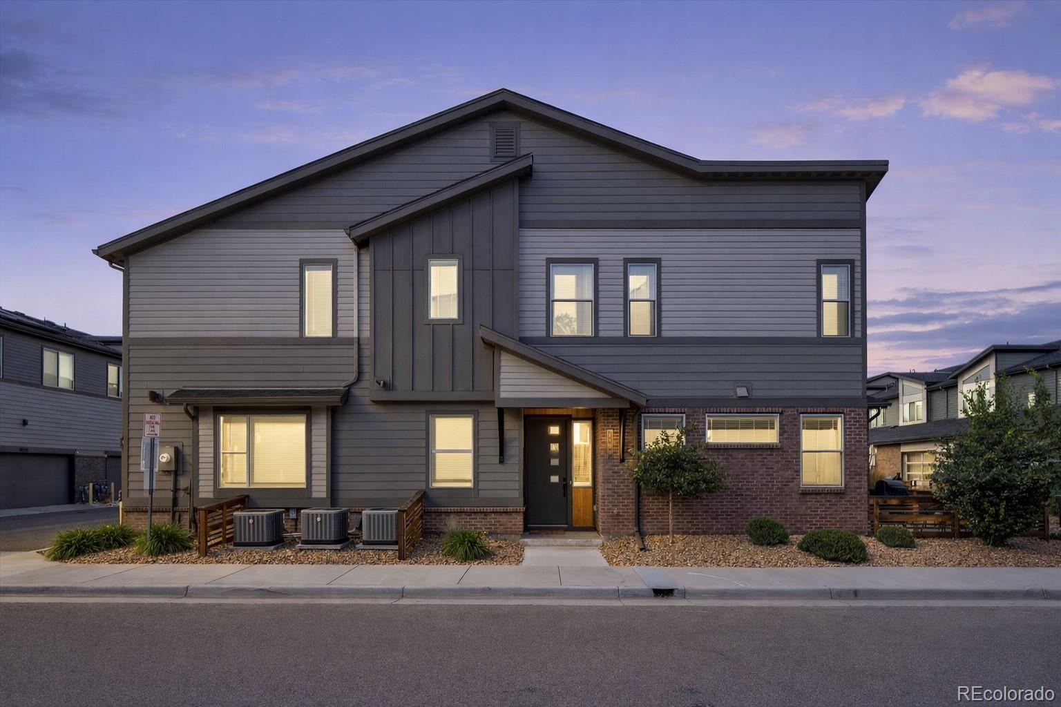 11772 West 45th Place Wheat Ridge, CO 80033 - Photo 2 of 25 a front view of a house with garden