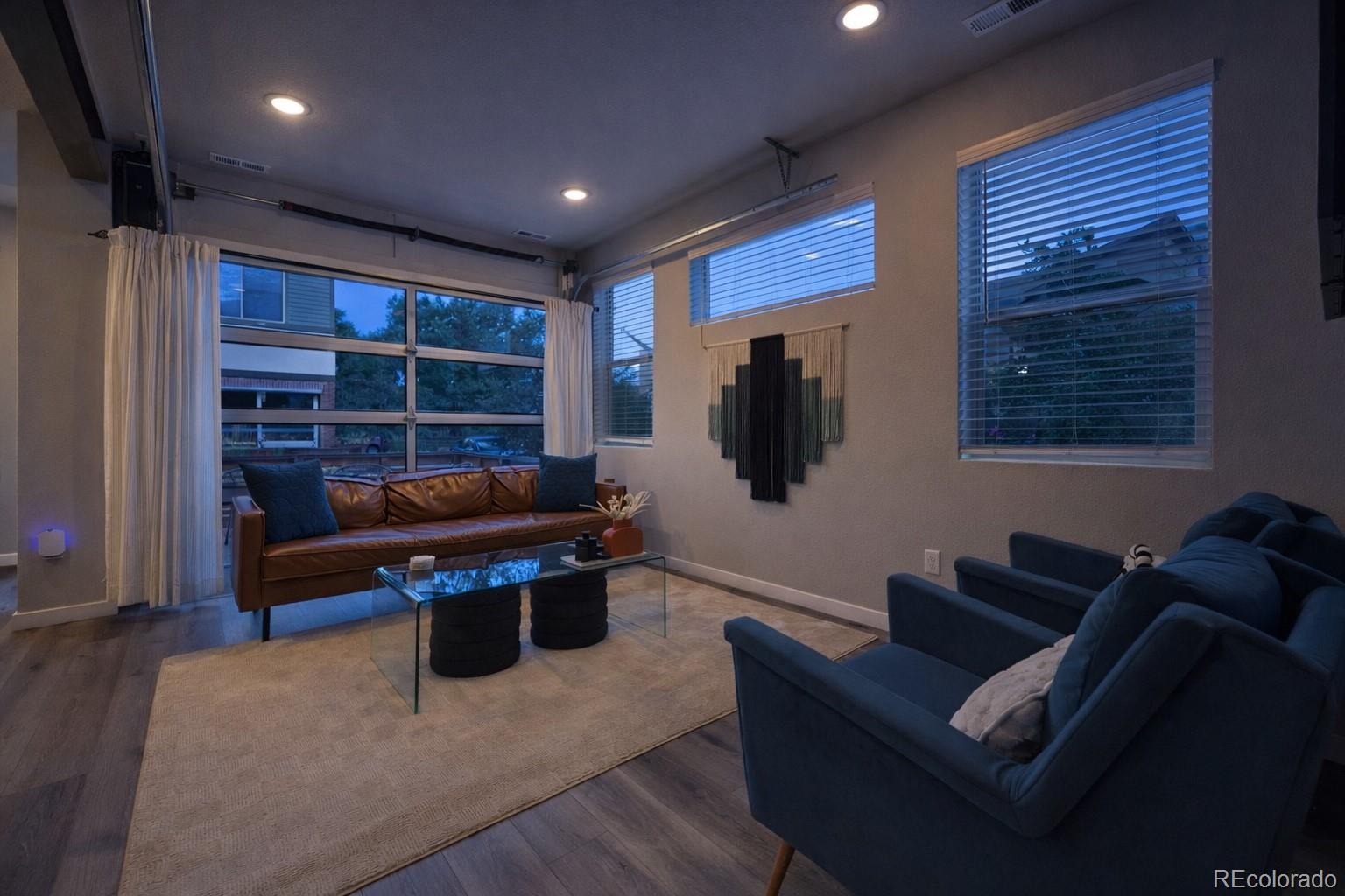 11772 West 45th Place Wheat Ridge, CO 80033 - Photo 3 of 25 a living room with furniture and a flat screen tv