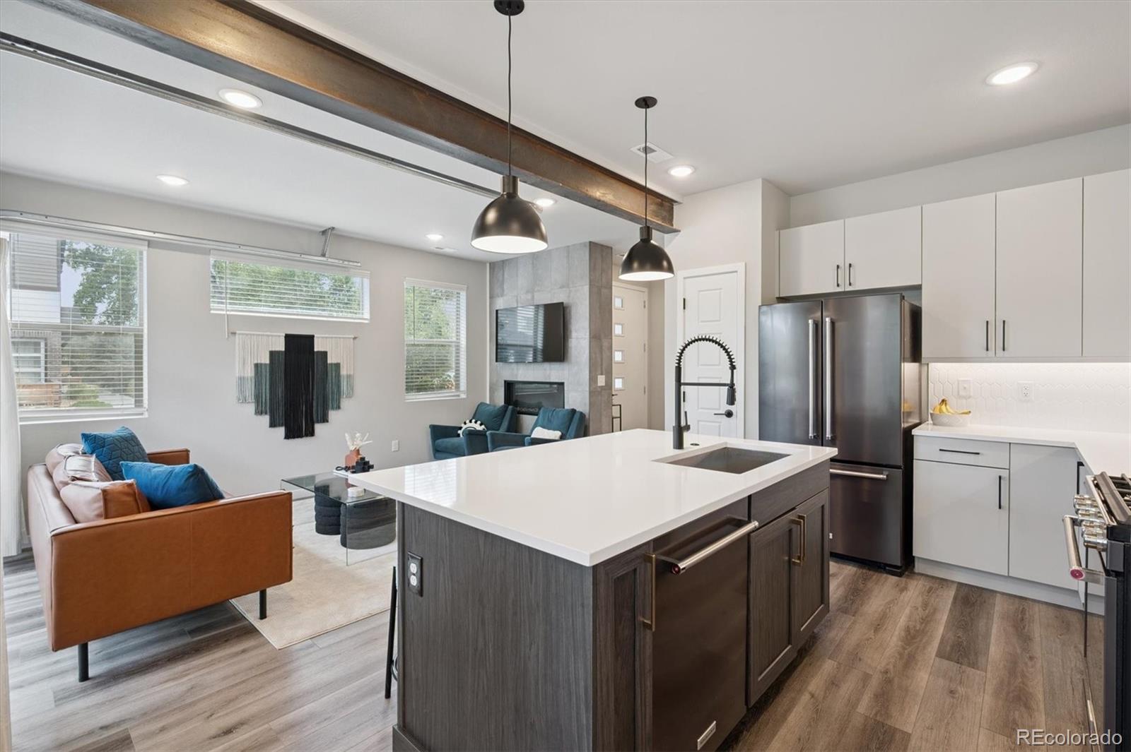 11772 West 45th Place Wheat Ridge, CO 80033 - Photo 8 of 25 a large kitchen with sink a refrigerator and cabinets