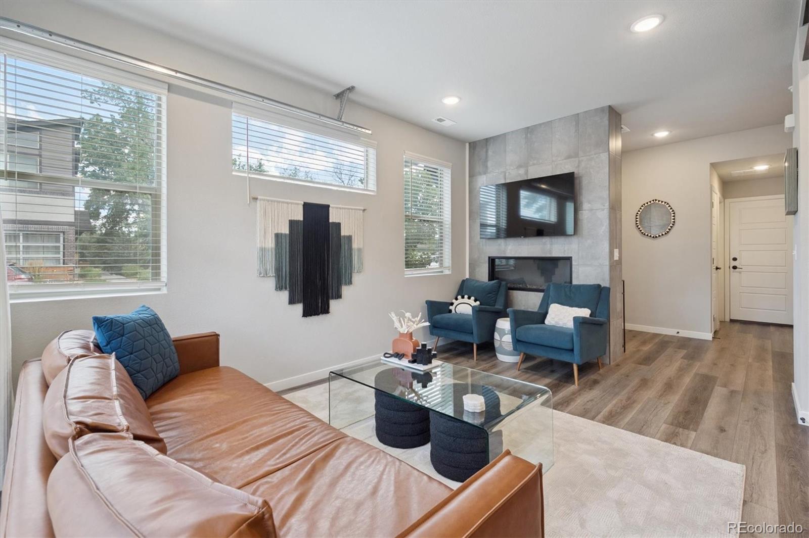 11772 West 45th Place Wheat Ridge, CO 80033 - Photo 9 of 25 a living room with furniture and a flat screen tv