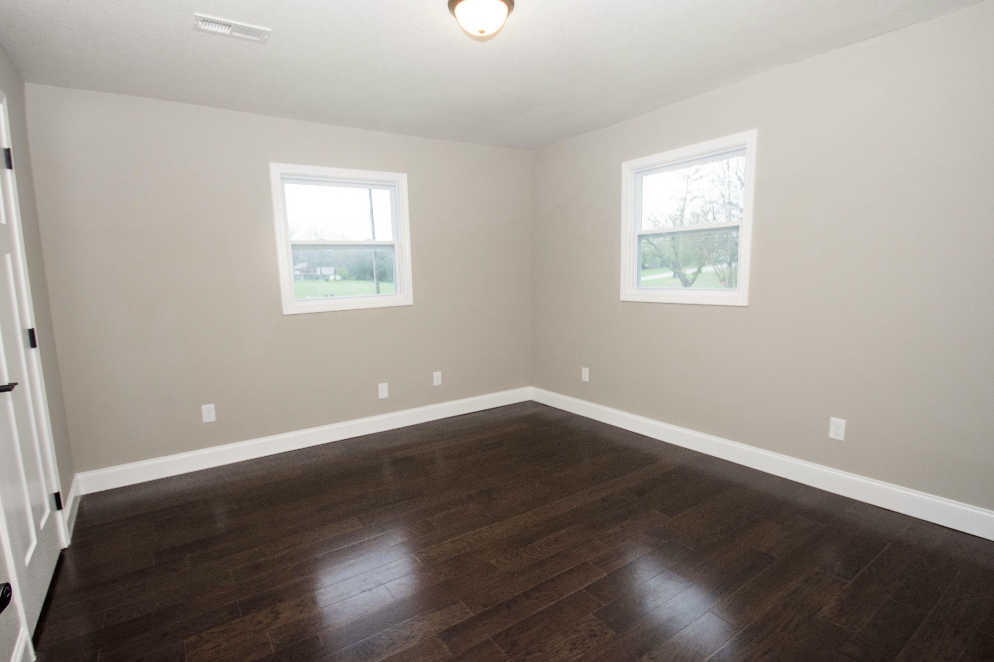 412 Cash Road Knoxville, TN 37924 - Photo 15 of 23 an empty room with wooden floor and windows