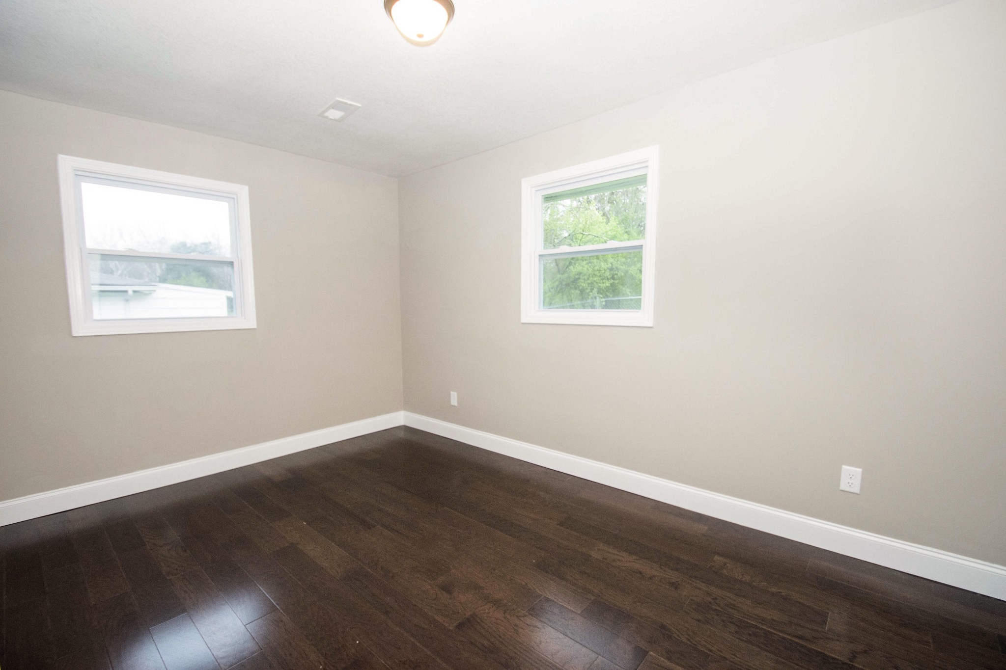 412 Cash Road Knoxville, TN 37924 - Photo 18 of 23 an empty room with wooden floor and windows