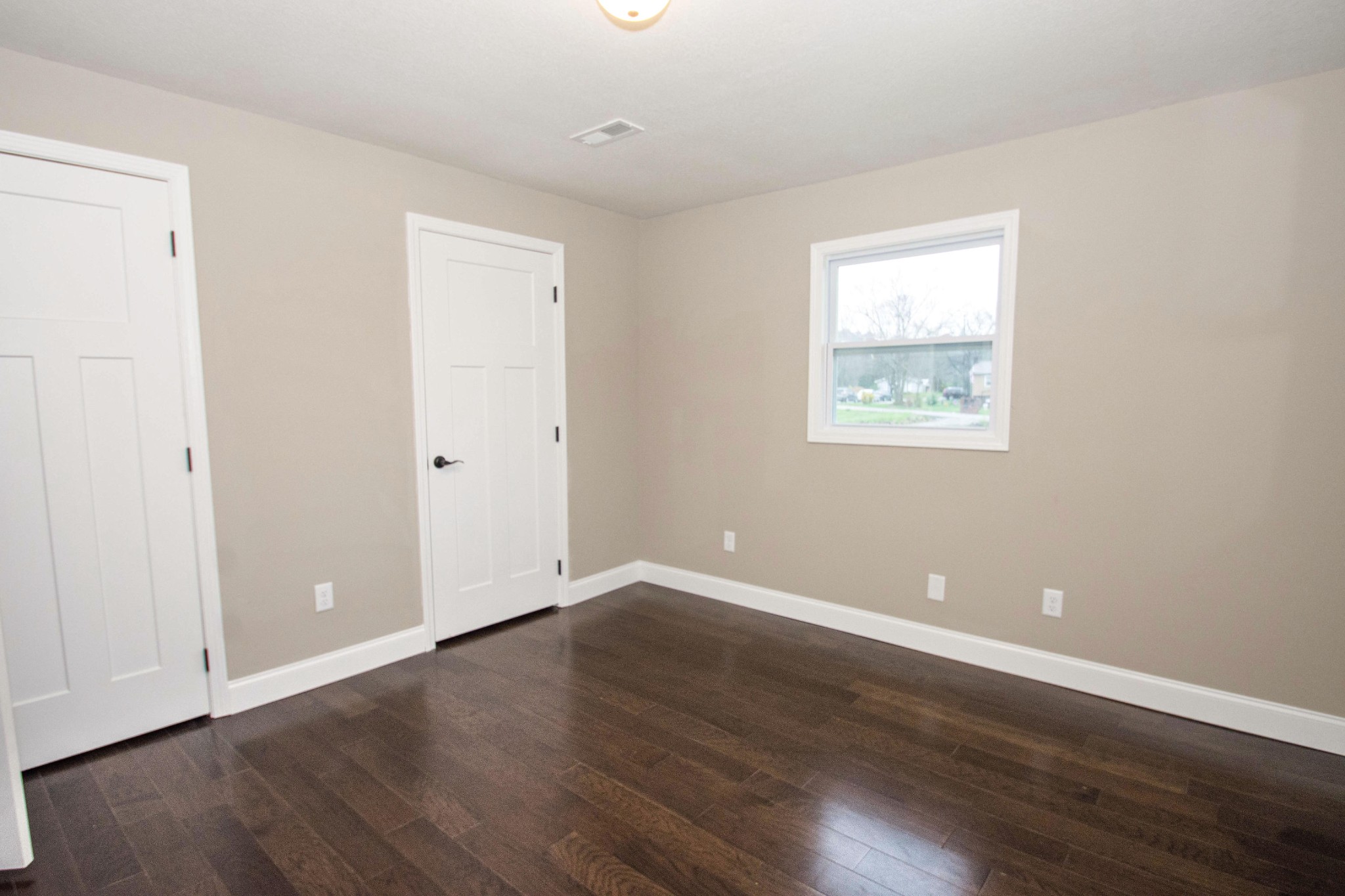 412 Cash Road Knoxville, TN 37924 - Photo 20 of 23 an empty room with wooden floor and windows