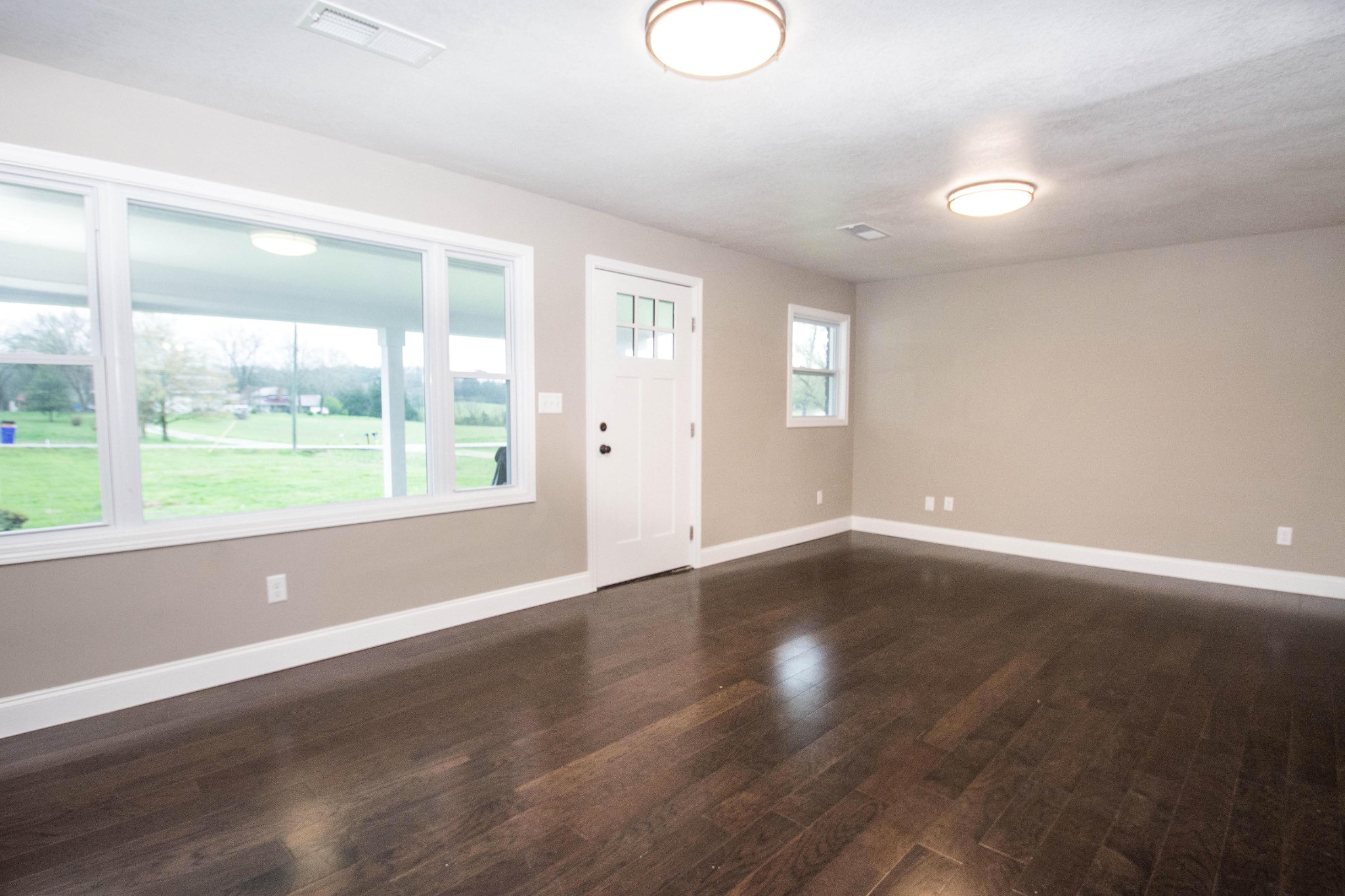 412 Cash Road Knoxville, TN 37924 - Photo 4 of 23 an empty room with wooden floor and windows