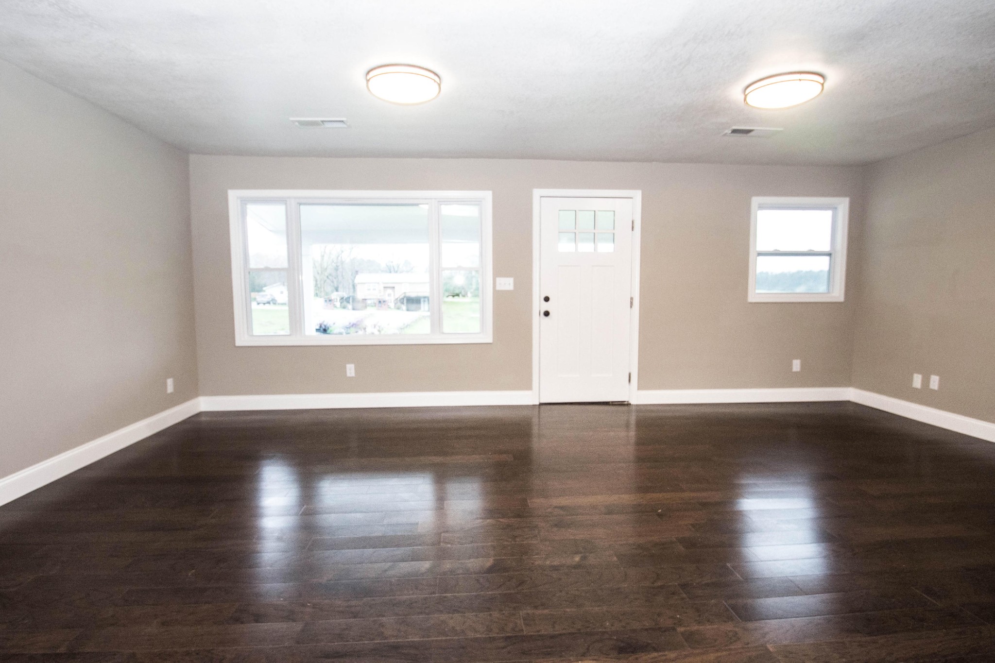 412 Cash Road Knoxville, TN 37924 - Photo 5 of 23 an empty room with wooden floor and windows