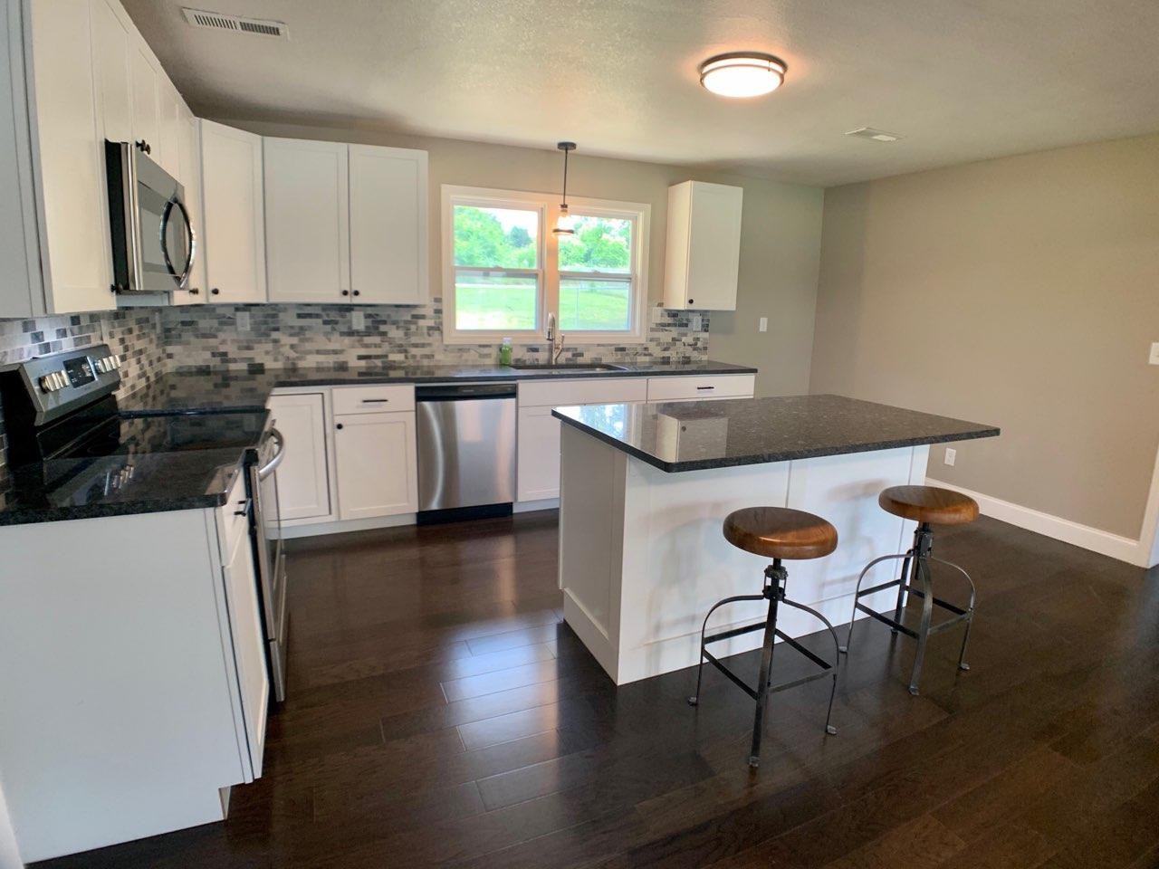 412 Cash Road Knoxville, TN 37924 - Photo 8 of 23 a kitchen with sink cabinets and wooden floor
