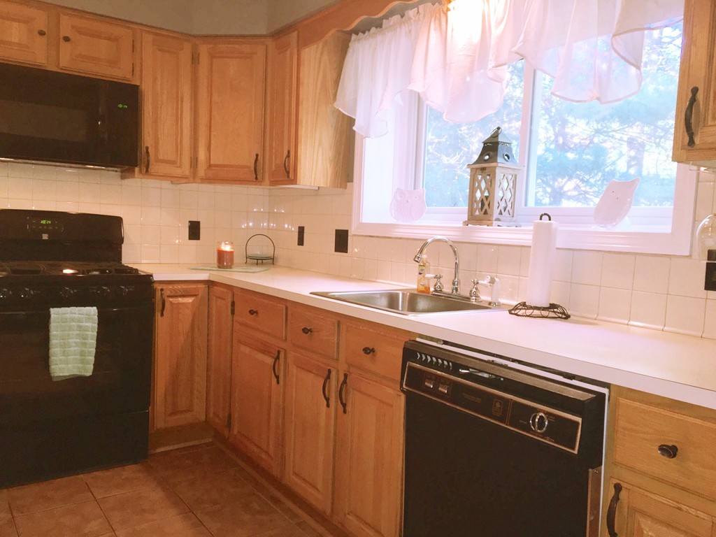 49 Captain Eames Circle, Unit 49 Ashland, MA 01721 - Photo 3 of 12 a kitchen with stainless steel appliances granite countertop a sink stove and microwave