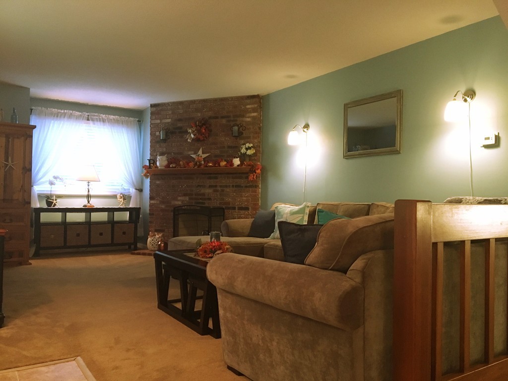 49 Captain Eames Circle, Unit 49 Ashland, MA 01721 - Photo 5 of 12 a living room with furniture and a fireplace