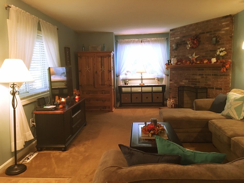 49 Captain Eames Circle, Unit 49 Ashland, MA 01721 - Photo 6 of 12 a living room with furniture and a fireplace