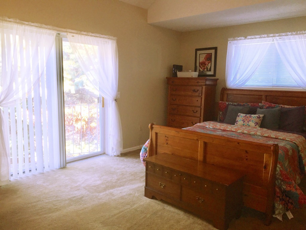 49 Captain Eames Circle, Unit 49 Ashland, MA 01721 - Photo 9 of 12 a bedroom with a bed and a window